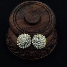 Impon ornate earrings with gemstones